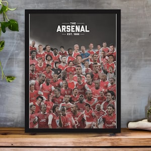 May include: A black framed poster with a collage of Arsenal Football Club players in their red and white jerseys. The poster has the text "THE ARSENAL EST. 1886" at the top.
