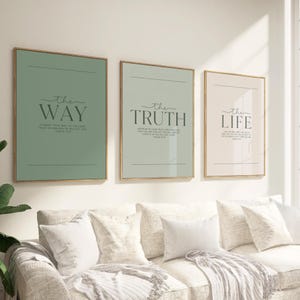 Puede incluir: Tres impresiones artísticas enmarcadas con marcos dorados cuelgan sobre un sofá. Las impresiones son en tonos verdes y beige, cada una con una palabra diferente en escritura elegante: "the WAY", "the TRUTH" y "the LIFE". Debajo de las palabras hay texto.