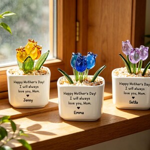 May include: Three small white square planters with glass tulip flowers in yellow, blue, and purple. Each planter has the text "Happy Mother's Day! I will always love you, Mom." and a name.