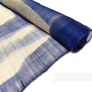 May include: A roll of blue and white striped mesh fabric. The fabric is made from a natural material and has a slightly textured surface.