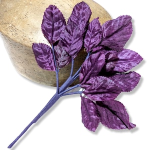 Könnte beinhalten: Ein Strauß aus violetten Samtblättern an einem Drahtstängel. Die Blätter sind in einer Gruppe angeordnet und haben eine strukturierte Oberfläche.