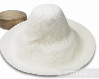 May include: A white straw hat with a wide brim and a tall crown. The hat is made of a woven material and has a smooth, even texture.