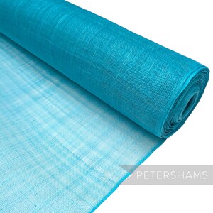 May include: A roll of turquoise blue mesh fabric. The fabric is lightweight and has a delicate texture.