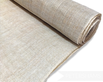 May include: A roll of natural-coloured burlap fabric with a subtle shimmer. The fabric is woven with a loose, open weave and has a slightly rough texture.