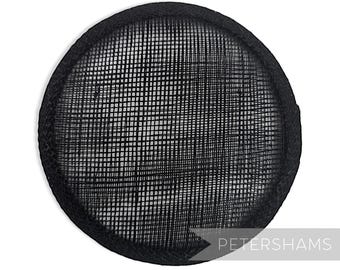 May include: Black round hat base made of a woven straw-like material. The base is about 4 inches in diameter.