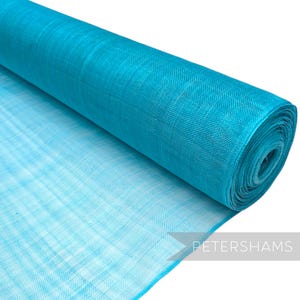 May include: A roll of turquoise blue mesh fabric. The fabric is lightweight and has a delicate texture.