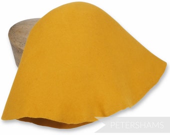 May include: A yellow felt hat, shaped like a cone, is displayed on a wooden form. The hat is made of a soft, pliable felt and has a smooth, even surface. The hat is a classic style and is perfect for a variety of occasions.