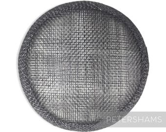 May include: A gray, round, woven hat base for millinery. The base is made of a fine, tightly woven material with a slightly textured surface.