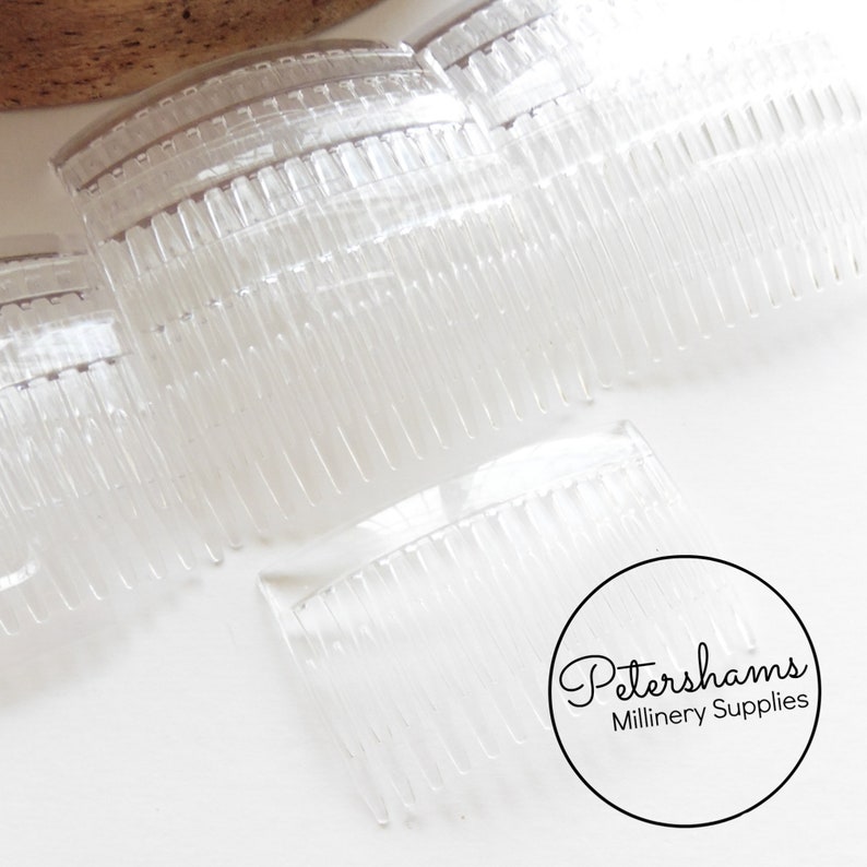 May include: A set of five clear plastic hair combs. The combs are curved and have a fine tooth design.