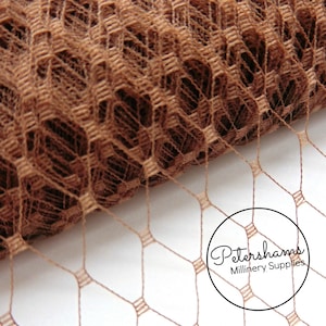 May include: A roll of brown, hexagonal-shaped, fine mesh netting. The netting is commonly used for millinery and craft projects.