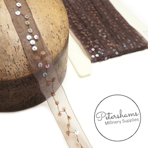 May include: Brown sheer ribbon with iridescent sequins sewn on in a staggered pattern. Petershams Millinery Supplies.
