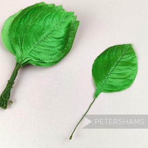 May include: A bunch of green silk leaves tied together with twine, and a single green silk leaf on a wire stem.  Petershams.