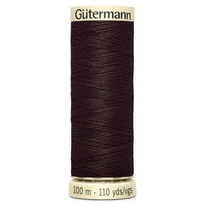 May include: A spool of dark brown sewing thread by Gütermann. The cylindrical spool features a cream-colored top label with the brand name and a cream-colored base printed with the length of 100 m - 110 yds/vgs. The thread is wound tightly.
