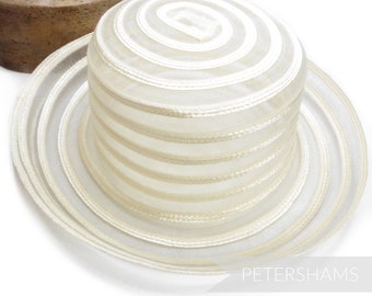 May include: A white straw hat with a wide brim and a layered crown. The hat has a subtle sheen and is made of a lightweight material.