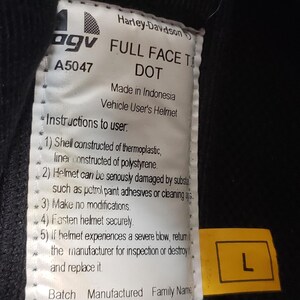 Peut inclure: Gros plan sur une &eacute;tiquette de casque int&eacute;gral Harley-Davidson. L'&eacute;tiquette comprend le logo de la marque, des informations sur le mod&egrave;le et des instructions de s&eacute;curit&eacute;. Une &eacute;tiquette jaune avec la lettre "L" indique la taille du casque.