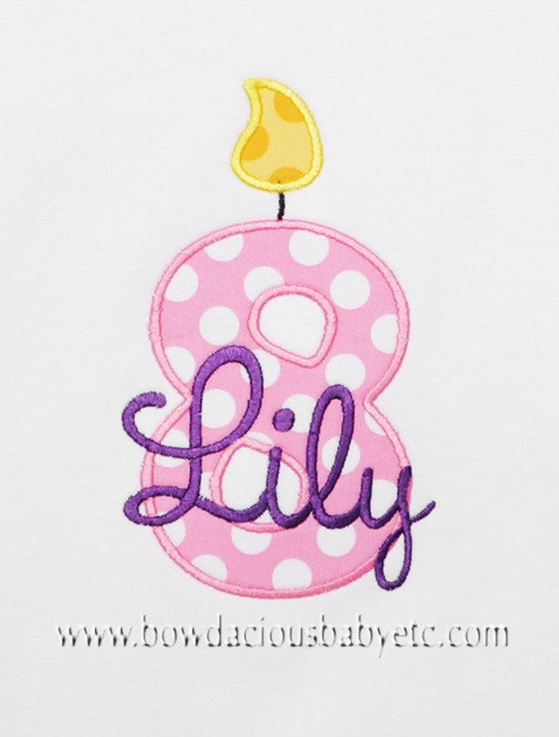 May include: Pink and white polka dot number eight candle with a yellow flame and the name "Lily" in purple cursive.