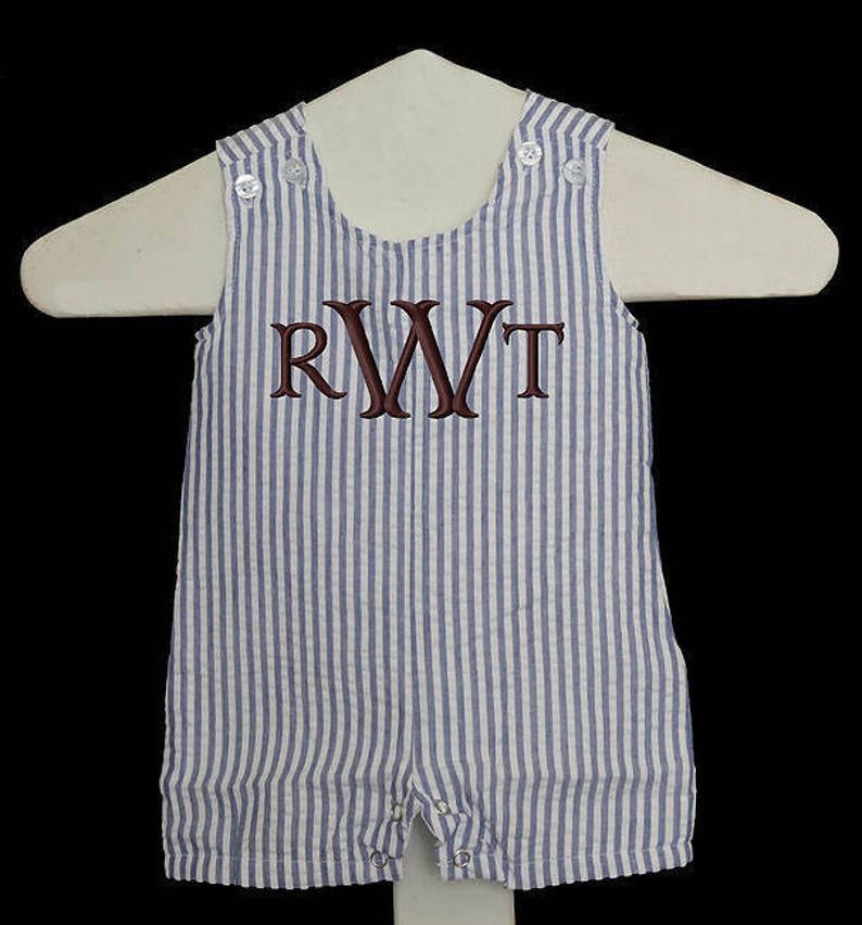May include: A blue and white striped baby onesie with a brown monogram "RWT" on the front.