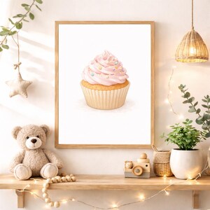 May include: A white ceramic mug with a black handle and the text "But First, Coffee" in a bold, black font. The mug is set against a blurred background, suggesting a cozy setting.