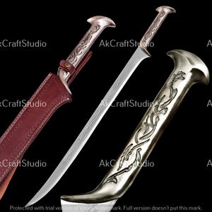 May include: A silver-colored sword with an ornate handle and blade. The blade has etched designs. The sword is partially sheathed in a brown leather scabbard. The handle has a curved design. The image has the text "AkCraftStudio".