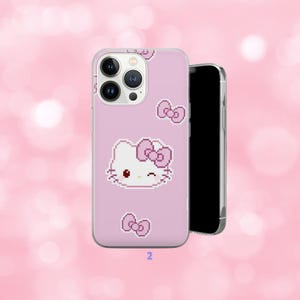 May include: A pink phone case featuring a pixelated Hello Kitty design with a bow and additional bow accents. The case is shown with a black smartphone, set against a soft pink background.