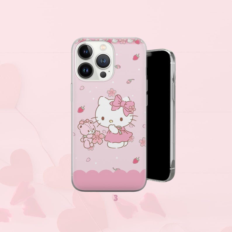 Puede incluir: Funda de tel&eacute;fono rosa con dise&ntilde;o de Hello Kitty. La funda presenta un lazo rosa, un vestido y un oso de peluche con flores. Tiene un borde transparente y un fondo rosa con fresas y flores. El n&uacute;mero "3" est&aacute; en la parte inferior.
