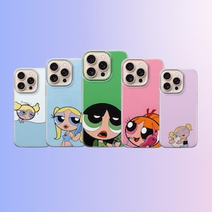 May include: A collection of five phone cases featuring cartoon characters from the Powerpuff Girls. Each case has a different color and character design, including Blossom, Bubbles, and Buttercup. The cases are in various shades of blue, green, pink, and purple.