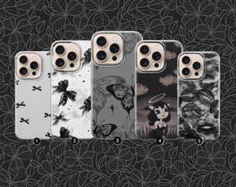 May include: A collection of five phone cases with various black and white designs. The designs include bows, butterflies, a cartoon angel, and lips. The cases are arranged in a row, showcasing different aesthetic styles.