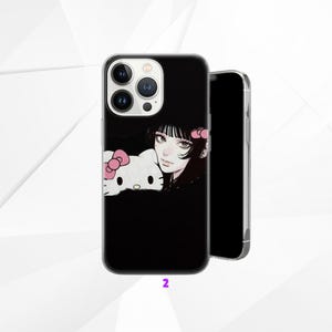 May include: Black phone case with a manga-style illustration of a woman and a Hello Kitty character with pink bows. The case has a clear border and a camera cutout. The number "2" is printed at the bottom.