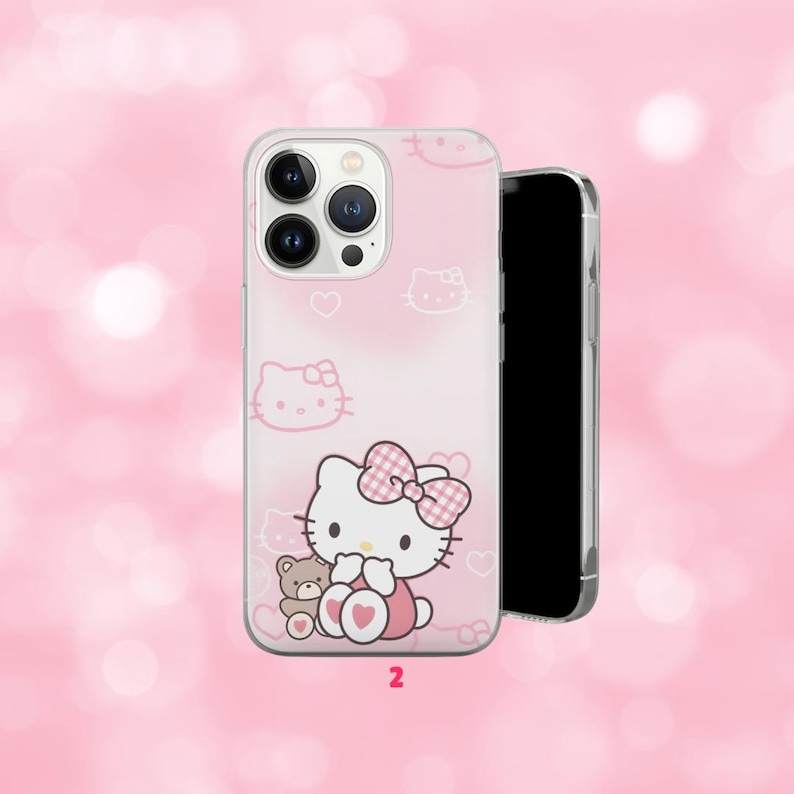 May include: A pink phone case featuring a cartoon cat with a pink bow and a teddy bear. The case has a repeating pattern of cat faces and hearts. The number "2" is printed at the bottom.