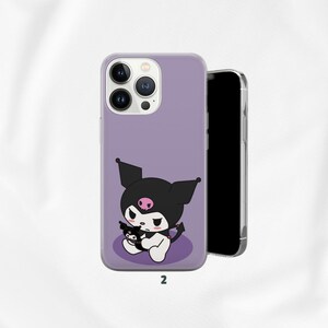 May include: A lavender phone case featuring a cartoon character with black ears, a black hat, and a pink skull on the forehead. The character is holding a smaller version of itself. The number "2" is printed at the bottom.