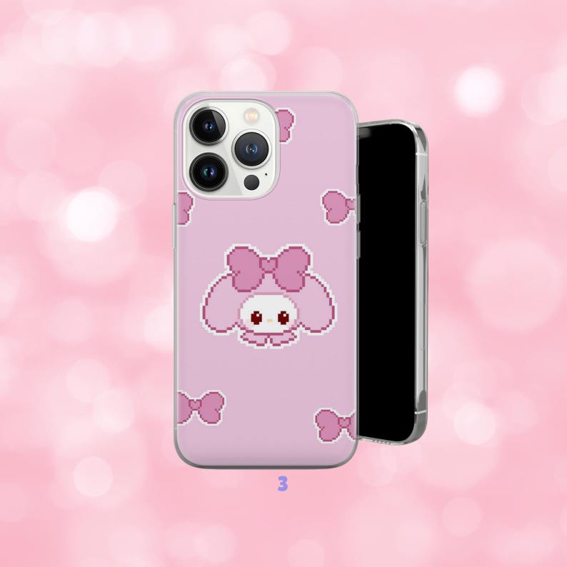 May include: A pink phone case featuring a pixelated cartoon character with a large bow and smaller bow accents. The case has a clear border and is shown with a black smartphone. The number "3" is printed at the bottom.