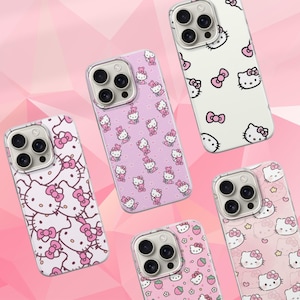 May include: A collection of phone cases featuring the Hello Kitty character. The cases have various designs, including pink bows, strawberries, and the character's face, set against pink and white backgrounds. The cases are designed to fit a phone with a triple-lens camera.