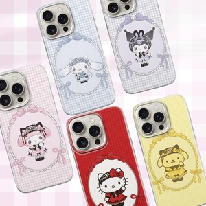 May include: A selection of phone cases with cartoon character designs. The cases feature characters such as Hello Kitty, My Melody, and Cinnamoroll. Each case has a different colour and design, set against a houndstooth pattern background with oval frames.