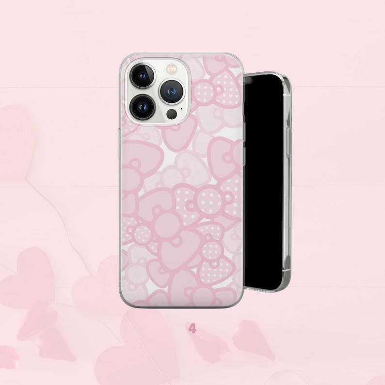 Puede incluir: Funda transparente para tel&eacute;fono con un dise&ntilde;o de lazo rosa. Los lazos tienen forma de coraz&oacute;n y lunares. Un smartphone negro est&aacute; al lado.