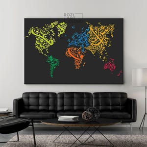 May include: A large black canvas print featuring a world map design created from colourful calligraphy. The calligraphy uses shades of green, blue, orange, yellow, and pink. The artwork hangs above a black leather sofa.