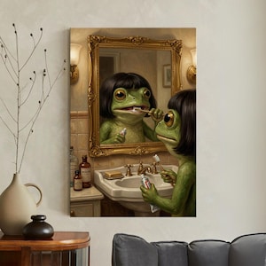 May include: A whimsical artwork depicts a green frog with black hair brushing its teeth in front of a gold-framed mirror. The frog is in a bathroom setting, with a sink, soap, and medicine bottles visible. The artwork has a surreal and humorous quality.