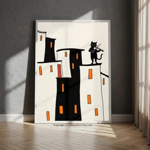 May include: A framed art print featuring a whimsical illustration of a black cat playing a violin on a rooftop. The buildings are white and black with orange window accents. The text "Copyright © LuminaPure.Etsy.com" is at the bottom.