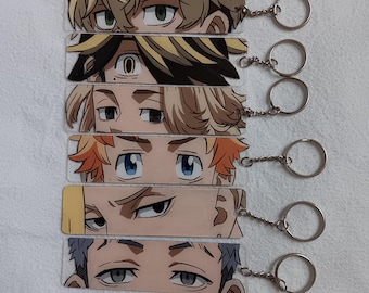 May include: A collection of five acrylic keychains featuring anime-style eye designs. Each keychain has a different eye color and hairstyle, with silver key rings attached. The keychains are rectangular and appear to be printed with vibrant colors.