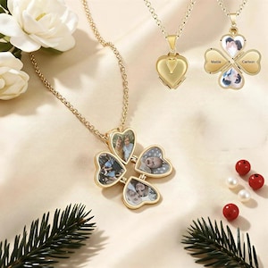May include: Gold-colored necklaces with heart-shaped lockets. One locket is a four-leaf clover design with photos inside, and the other is a heart shape. The clover locket has the names "Matie" and "Carlson" on it.