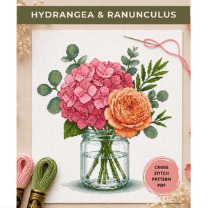 May include: A cross stitch pattern PDF titled HYDRANGEA & RANUNCULUS featuring a bouquet of pink hydrangea and orange ranunculus flowers in a clear glass mason jar, accompanied by green foliage, a needle with pink thread, and embroidery floss.