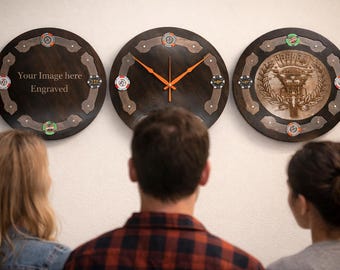 May include: Three round wooden wall clocks with poker chip accents. The center clock has orange hands. The left clock has the text "Your Image here Engraved". The right clock has a detailed engraved design.