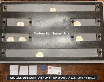 May include: A rectangular challenge coin display top with six slots, each holding a coin. The display is made of gray wood and metal, with the text "Custom Text/Image Here" and "CHALLENGE COIN DISPLAY TOP (FOR CONCEALMENT BOX)".