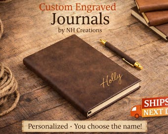 May include: A brown, personalized journal with the name "Holly" engraved in gold lettering. The journal is on a wooden surface with a pen and other journals in the background. The text "Custom Engraved Journals" is at the top.