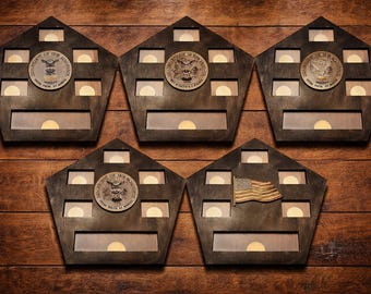 May include: Five wooden display cases in a pentagon shape, each with a dark brown finish. Each case has a circular emblem and several rectangular openings. One case features a small American flag.