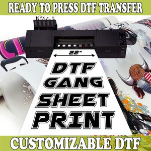May include: A white sheet of DTF transfer paper with black text that reads "DTG GANG SHEET PRINT" and "CUSTOMIZABLE DTF". The sheet is 22 inches wide and is being printed on a large format printer.