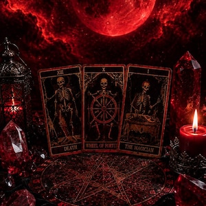 May include: Three tarot cards labeled Death, Wheel of Fortune, and The Magician are displayed alongside a metal lantern, red candles, red crystals, and an ornate key. A circular mat with a pentagram design sits beneath the cards.