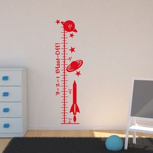 May include: Red rocket ship and planets themed growth chart with a white background. The chart measures from 2 to 5 feet in height. The text on the chart reads "3-2-1 Blast-Off!"