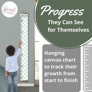 May include: A white and green canvas growth chart with a black and white checkered pattern. The chart is mounted on a wooden frame and has a ruler on the side. The text "Christopher Scott" is printed at the top of the chart. The text "Progress They Can See for Themselves" is printed in a green circle. The text "Hanging canvas chart to track their growth from start to finish" is printed below the circle.