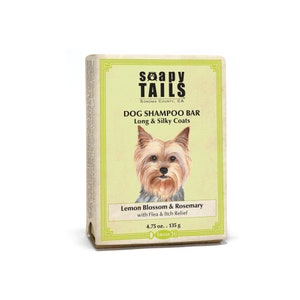 May include: A dog shampoo bar with a light green label featuring a Yorkshire Terrier illustration. The label reads "Soapy Tails" and "Dog Shampoo Bar" with the scent "Lemon Blossom & Rosemary". The bar weighs 4.75 oz.