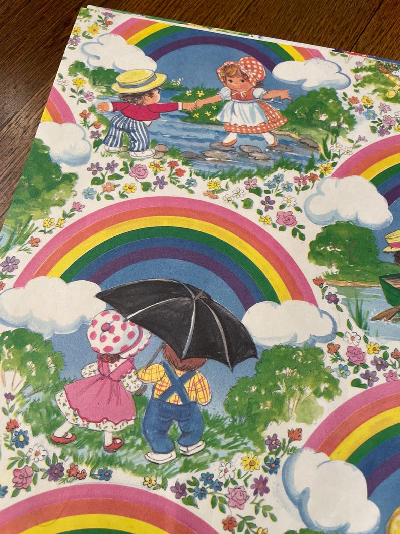 May include: A vibrant illustration with children, rainbows, and clouds. One scene shows two children crossing a stream, while another depicts two children under an umbrella. The artwork is framed by rainbows and floral details.